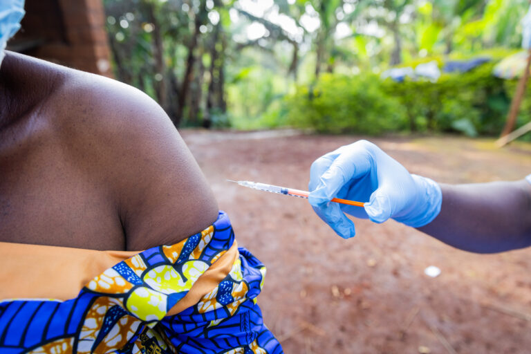 A woman's shoulder ready to receive a vaccine from a general practitioner